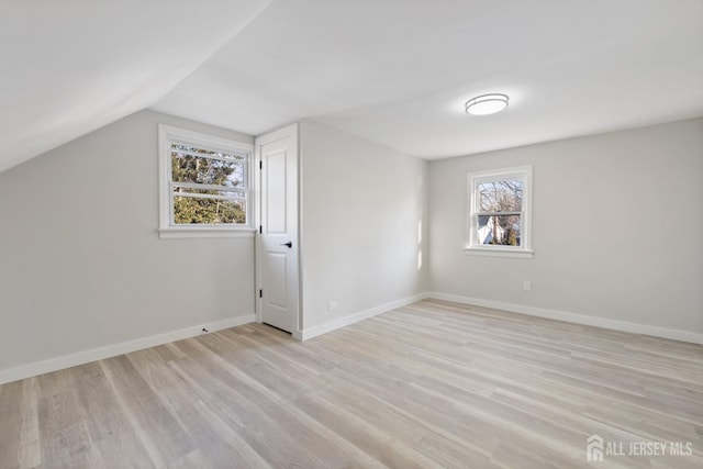 bonus room featuring lofted ceiling and light hardwood / wood-style floors