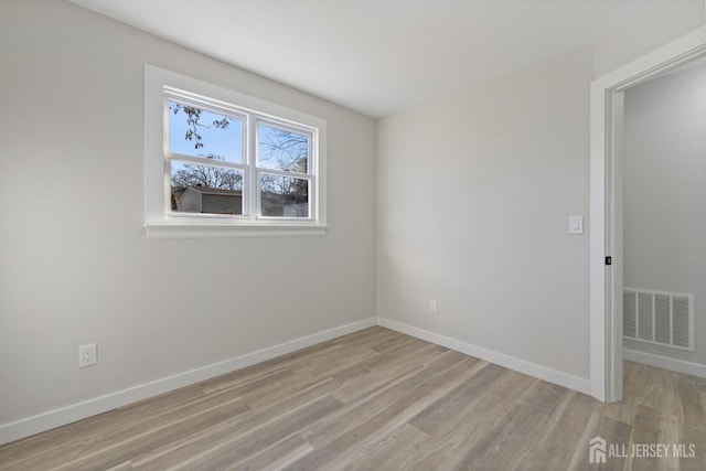 spare room with light hardwood / wood-style floors