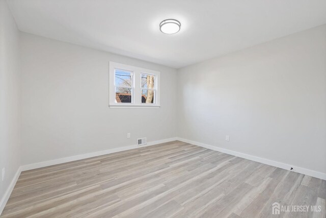 unfurnished room with light hardwood / wood-style floors