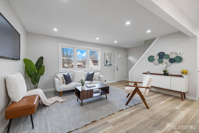 living area with light wood-style floors, recessed lighting, baseboards, and stairs