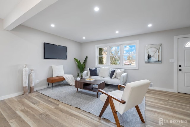 living area featuring light wood-style flooring, baseboards, and recessed lighting