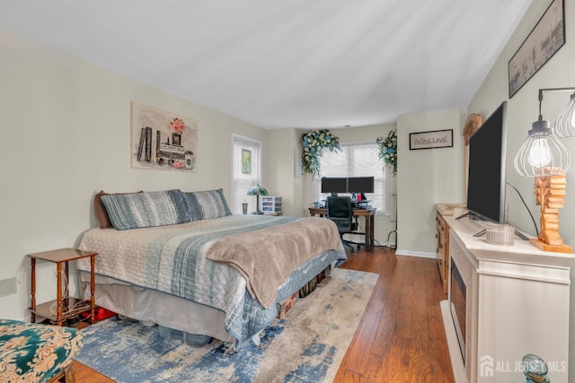 bedroom featuring baseboards and dark wood finished floors