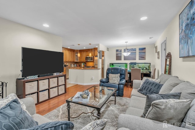 living area featuring recessed lighting and light wood finished floors