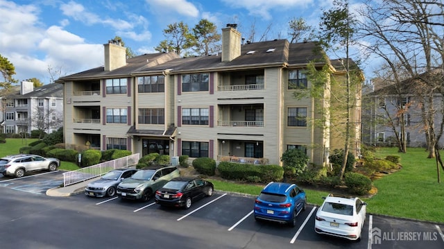 view of building exterior with uncovered parking