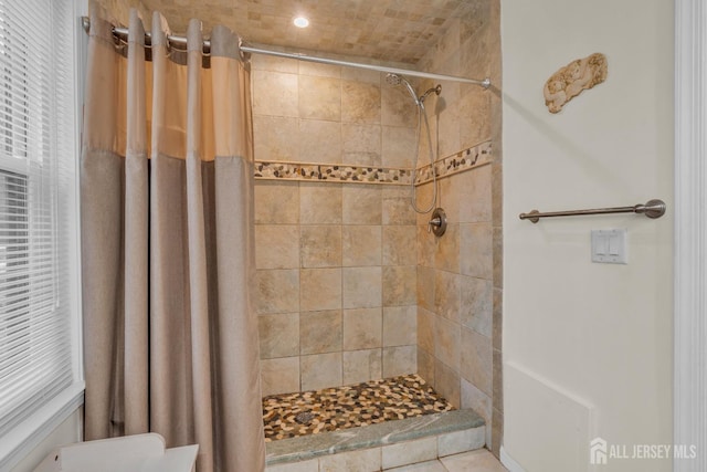 bathroom with a tile shower