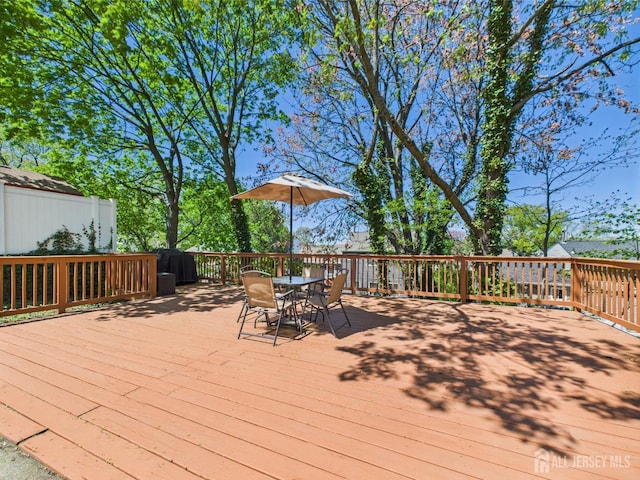 wooden terrace with outdoor dining area