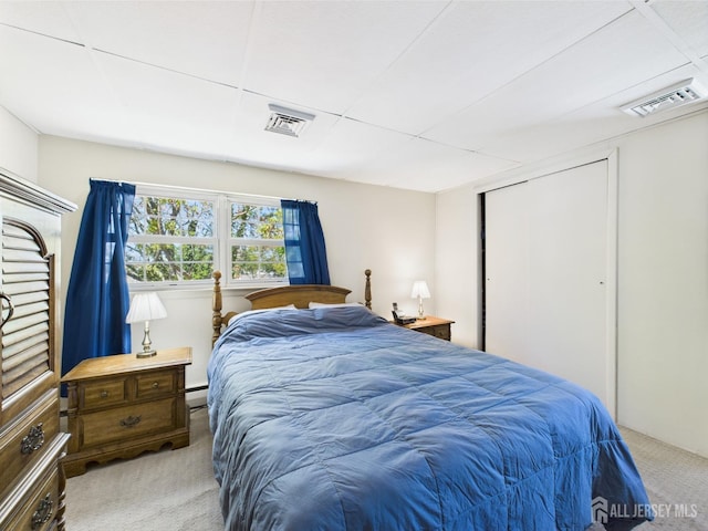 bedroom featuring a closet, visible vents, carpet, and a baseboard radiator