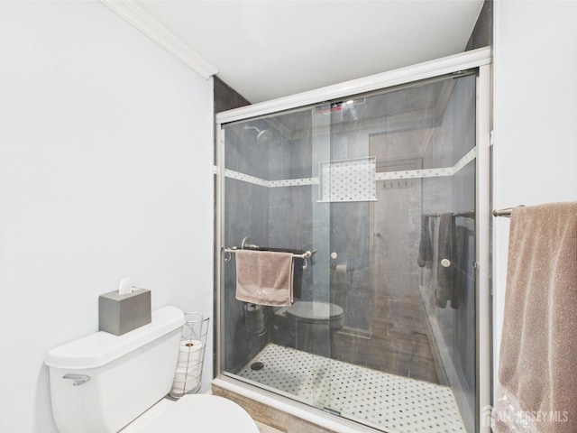 full bathroom with toilet, a shower stall, and ornamental molding
