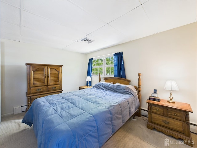 carpeted bedroom with baseboards, visible vents, and a baseboard radiator