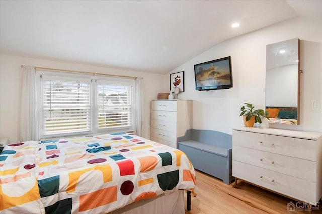 bedroom featuring vaulted ceiling and light hardwood / wood-style flooring