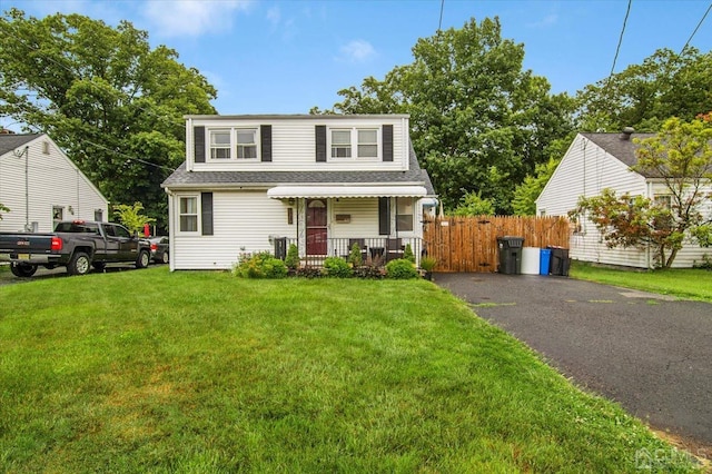 view of front of property with covered porch and a front yard