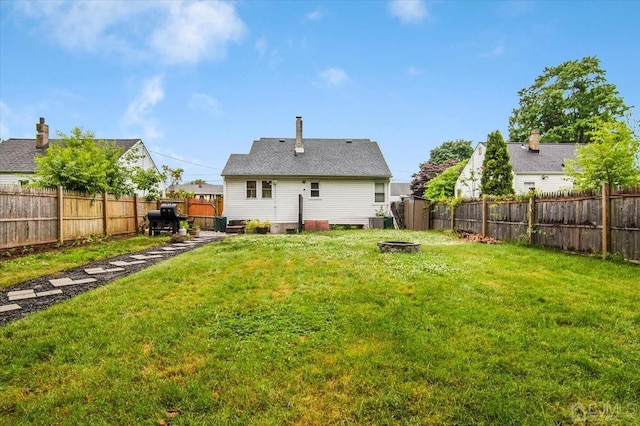 rear view of property featuring a yard