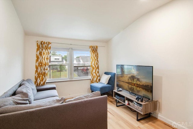 living room featuring light hardwood / wood-style flooring and lofted ceiling