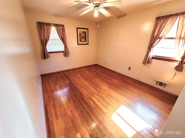 694 Vincent Pl, Perth Amboy, NJ 08861 - spare room with wood finished floors, ceiling fan, and baseboards