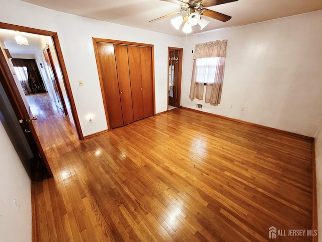 694 Vincent Pl, Perth Amboy, NJ 08861 - unfurnished bedroom featuring wood-type flooring, baseboards, a closet, and ceiling fan
