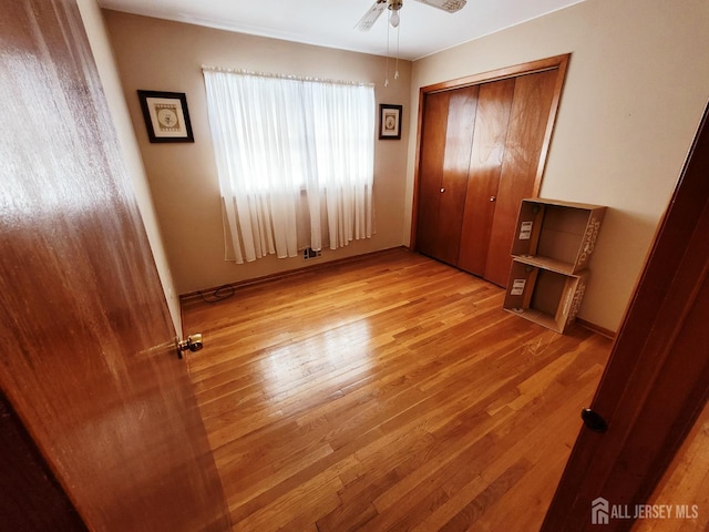694 Vincent Pl, Perth Amboy, NJ 08861 - unfurnished bedroom with light wood-style floors, a closet, and ceiling fan