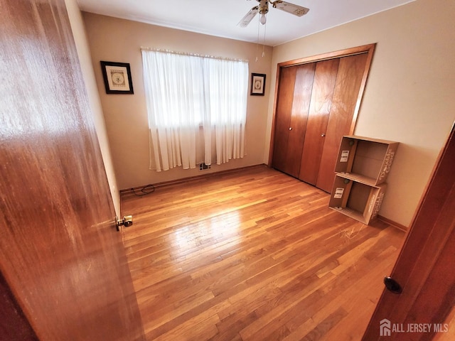 694 Vincent Pl, Perth Amboy, NJ 08861 - unfurnished bedroom featuring wood finished floors, a closet, and a ceiling fan