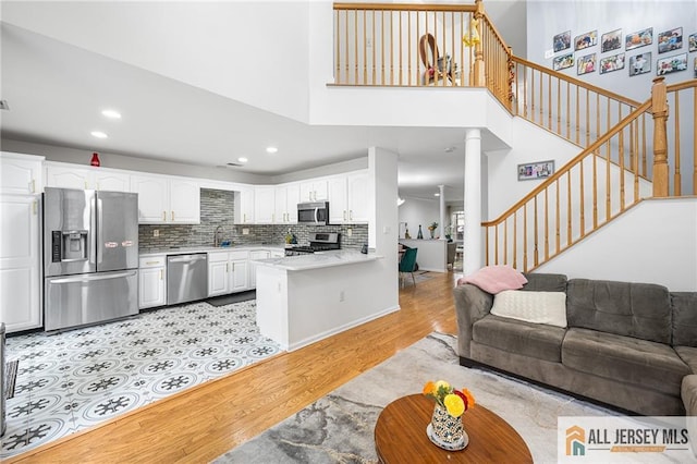202 Canterbury Way S, Brunswick, NJ 08540 - living room featuring light wood-type flooring, recessed lighting, stairway, ornate columns, and a high ceiling