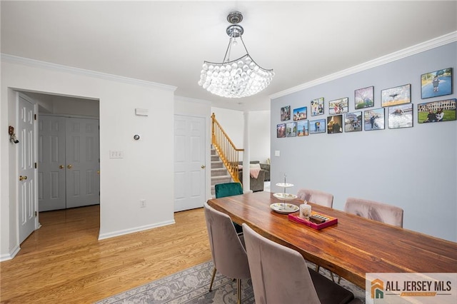 202 Canterbury Way S, Brunswick, NJ 08540 - dining room featuring stairs, crown molding, light wood-style floors, a chandelier, and baseboards