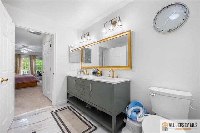 202 Canterbury Way S, Brunswick, NJ 08540 - ensuite bathroom featuring double vanity, toilet, baseboards, and a ceiling fan