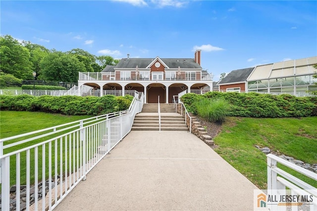 202 Canterbury Way S, Brunswick, NJ 08540 - view of front of property with stairs, a porch, a chimney, and a balcony