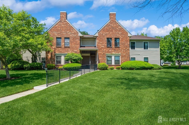 114 Griggs Pl E, Brunswick, NJ 08816 - view of front of house with a chimney and brick siding