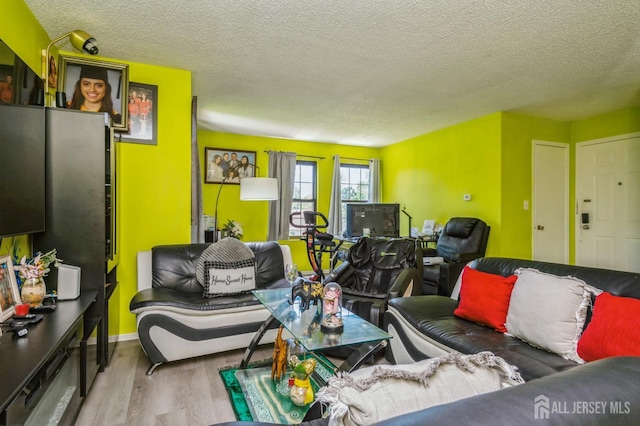 114 Griggs Pl E, Brunswick, NJ 08816 - living area featuring wood finished floors and a textured ceiling