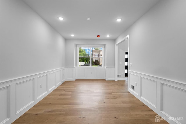 75 Jefferson Blvd, Edison, NJ 08817 - empty room with a decorative wall, a wainscoted wall, recessed lighting, and light wood-type flooring