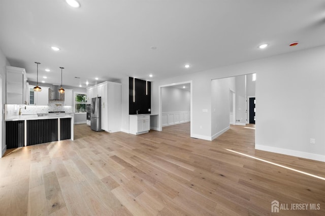75 Jefferson Blvd, Edison, NJ 08817 - unfurnished living room with light wood-style floors, recessed lighting, and baseboards