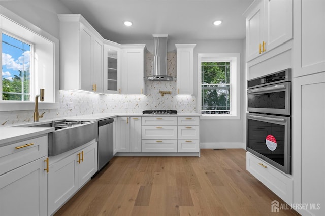 75 Jefferson Blvd, Edison, NJ 08817 - kitchen with wall chimney exhaust hood, stainless steel appliances, light wood-style flooring, white cabinets, and recessed lighting