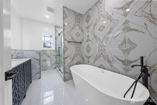 75 Jefferson Blvd, Edison, NJ 08817 - full bath with tile walls, vanity, a freestanding tub, and a marble finish shower