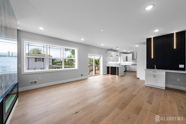 75 Jefferson Blvd, Edison, NJ 08817 - unfurnished living room with light wood finished floors, baseboards, and recessed lighting