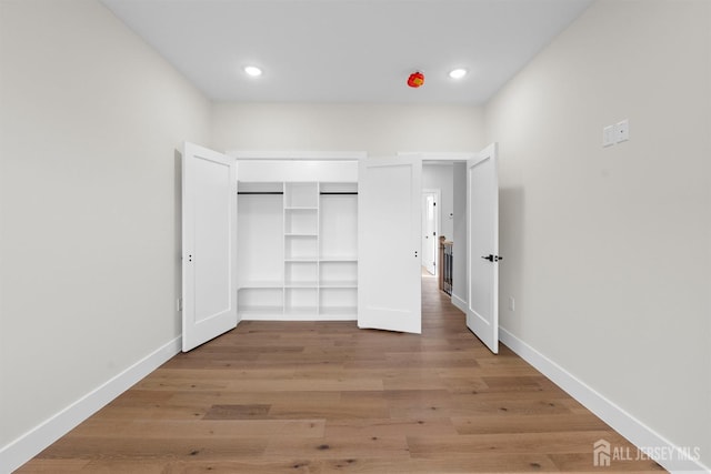 75 Jefferson Blvd, Edison, NJ 08817 - unfurnished bedroom with light wood-type flooring, recessed lighting, and a closet
