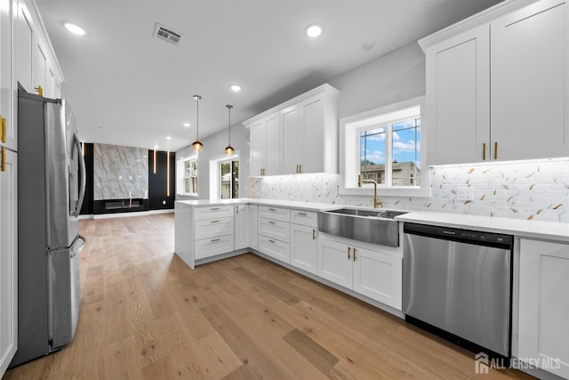 75 Jefferson Blvd, Edison, NJ 08817 - kitchen with appliances with stainless steel finishes, a sink, a peninsula, white cabinetry, and recessed lighting