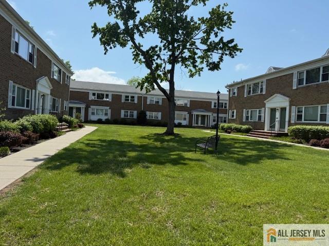 view of home's community with a lawn