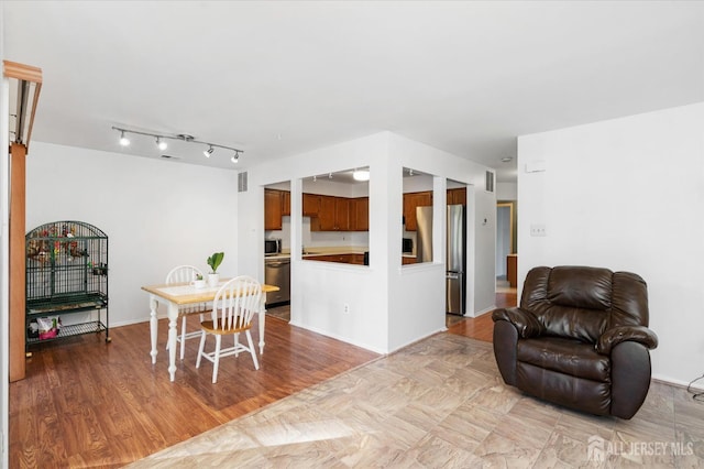 dining room with baseboards, visible vents, and wood finished floors