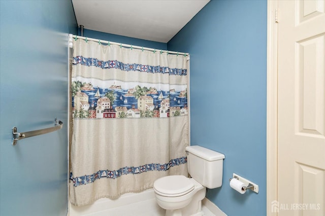 bathroom featuring curtained shower and toilet