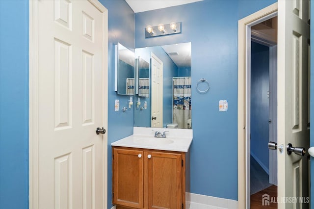 bathroom with vanity and baseboards