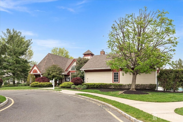 view of front of house with a front lawn and a chimney