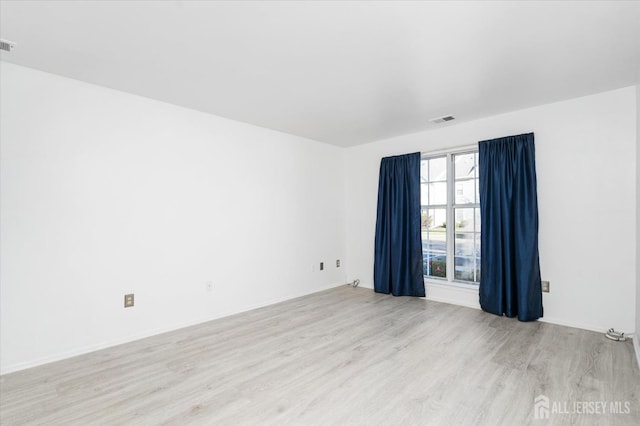 spare room with visible vents and light wood-style flooring