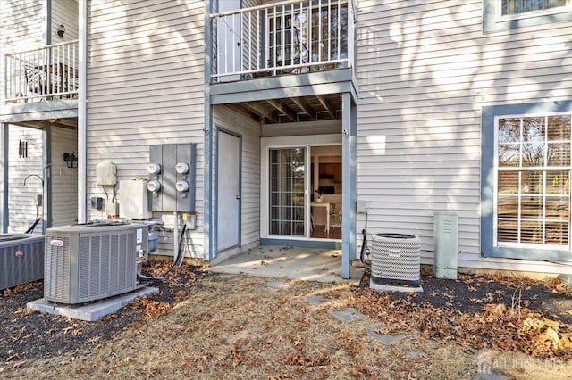 exterior space featuring central air condition unit and a balcony