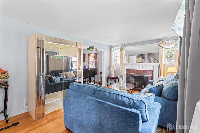 434 Orchard St, Rahway, NJ 07065 - living area with plenty of natural light, light wood-type flooring, a brick fireplace, and baseboards