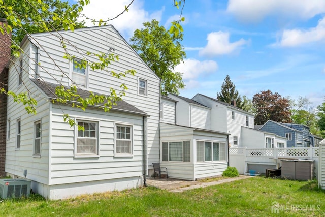 434 Orchard St, Rahway, NJ 07065 - rear view of house featuring central AC, a sunroom, and roof with shingles