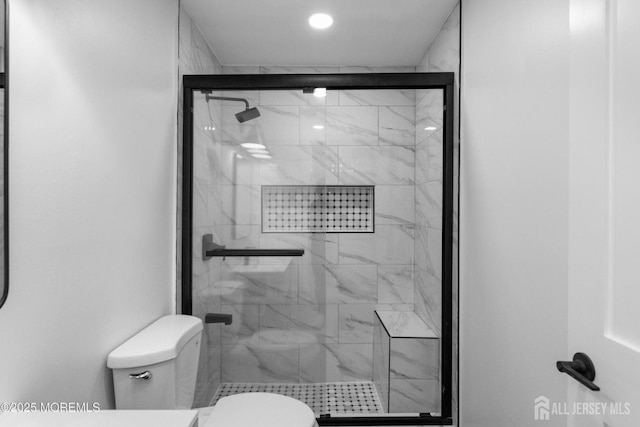 full bath featuring toilet and a shower stall