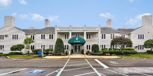 view of building exterior featuring uncovered parking