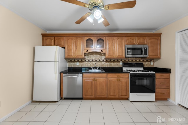 1004 Cricket Ln, Woodbridge Proper, NJ 07095 - kitchen featuring appliances with stainless steel finishes, crown molding, dark countertops, and brown cabinets