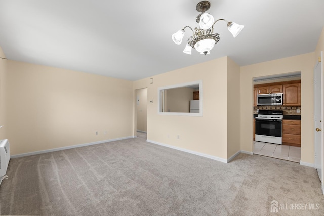 1004 Cricket Ln, Woodbridge Proper, NJ 07095 - unfurnished living room with light colored carpet and a chandelier
