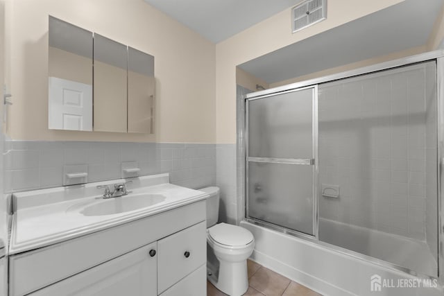 1004 Cricket Ln, Woodbridge Proper, NJ 07095 - full bath with vanity, tile walls, shower / bath combination with glass door, tile patterned flooring, and wainscoting