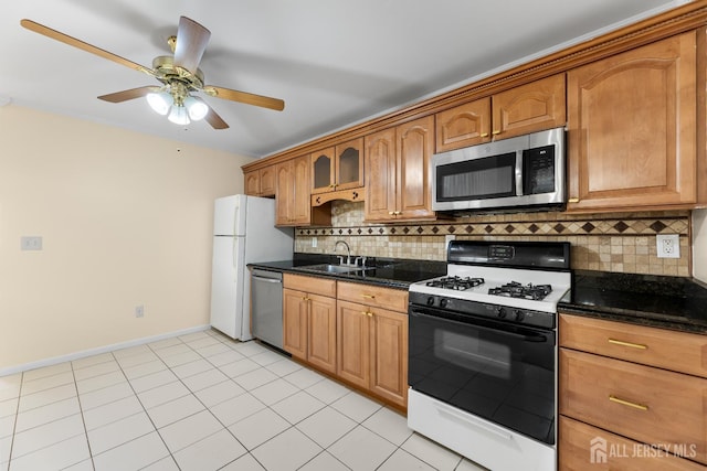 1004 Cricket Ln, Woodbridge Proper, NJ 07095 - kitchen featuring stainless steel appliances, a ceiling fan, decorative backsplash, dark stone countertops, and brown cabinetry