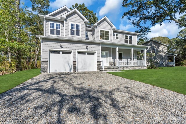 craftsman house with a porch, a front lawn, and a garage